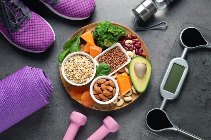 Plate with heart-healthy products and sports equipment